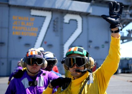 US Navy 070508-N-7981E-152 Flight deck personnel stand ready to fight a fire during a simulated crash scenario on the flight deck of Nimitz-class aircraft carrier USS Abraham Lincoln (CVN 72) photo