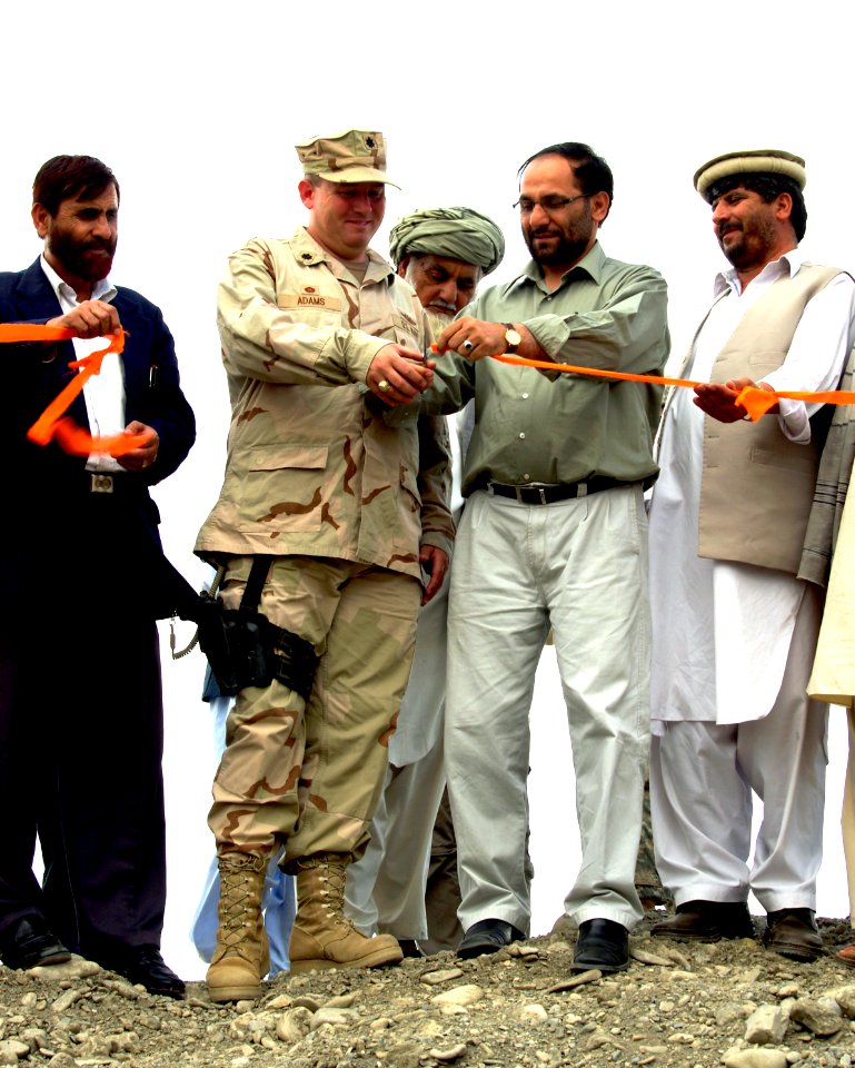 US Navy 070508-N-3385W-004 Cmdr. Dave Adams and the governor of Khost cut the ribbon to the construction site right before the first stone is laid for one of 30 diversion dams planned for Khost Province