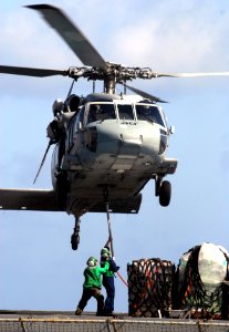 US Navy 070515-N-3038W-210 Sailors from USNS Bridge (T-AOE 10) attach supplies to an MH-60S Seahawk from the