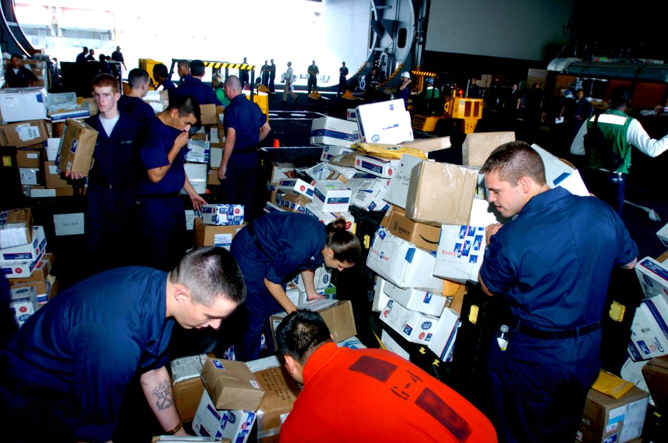 US Navy 070510-N-4420S-081 Sailors work together to sort the mail during replenishment at sea with Military Sealift Command (MSC) fleet replenishment oiler USNS Kanawha (T-AO 196)