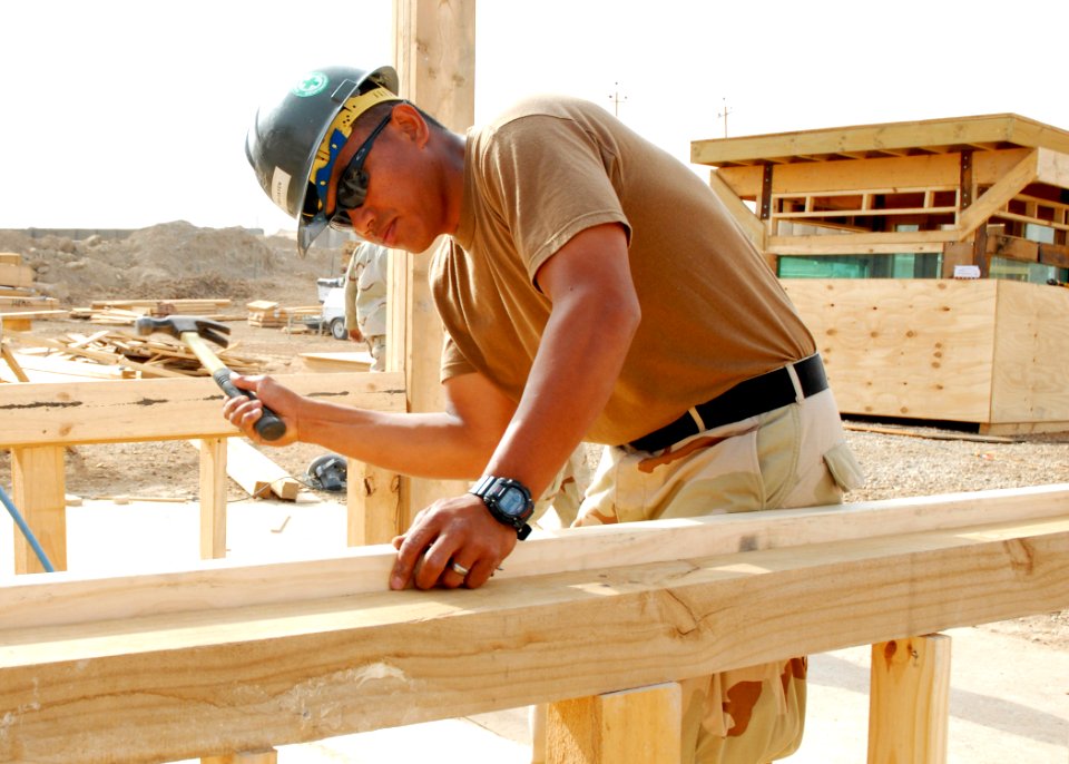 US Navy 070515-N-3560G-042 Utilitiesman 3rd Class Heranio Wagayen of Naval Mobile Construction Battalion (NMCB) 4 constructs a Modular Protected Building (MPB) to be used for guard shacks and billeting