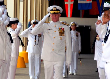 US Navy 070508-N-4965F-002 Adm. Robert F. Willard, former Vice Chief of Naval Operations, salutes as he's piped through the sideboys during a change of command ceremony photo