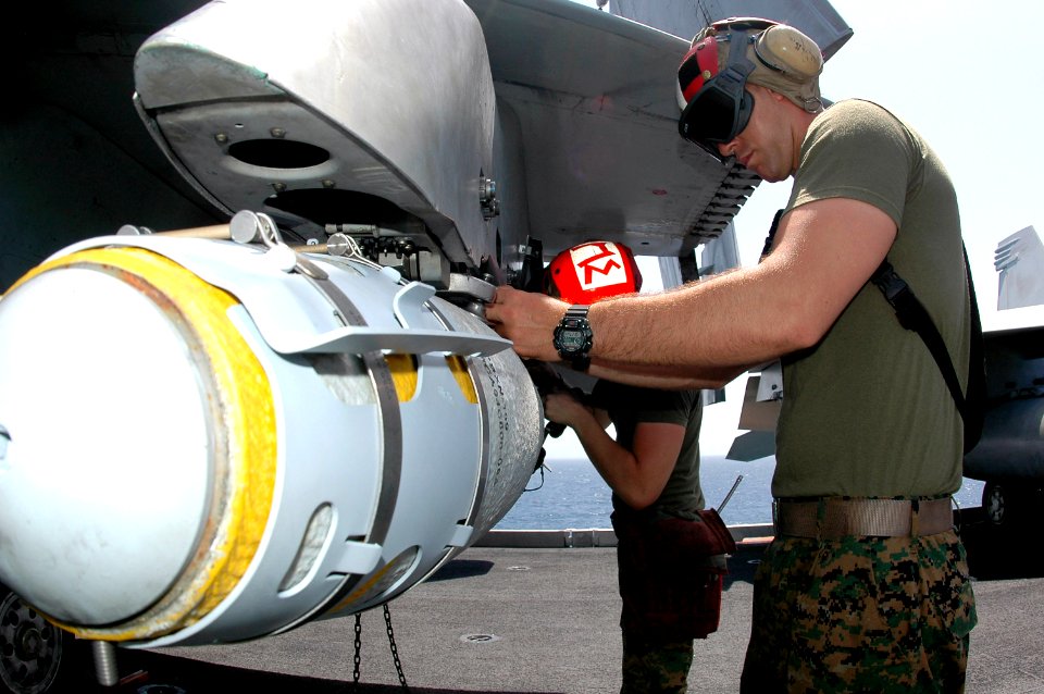 US Navy 070509-N-9760Z-005 Lance Cpl. Ryan Adair, assigned to the Red Devils of Marine Fighter Attack Squadron (VMFA) 232, loads a GBU-38 bomb onto an F-A-18B Hornet