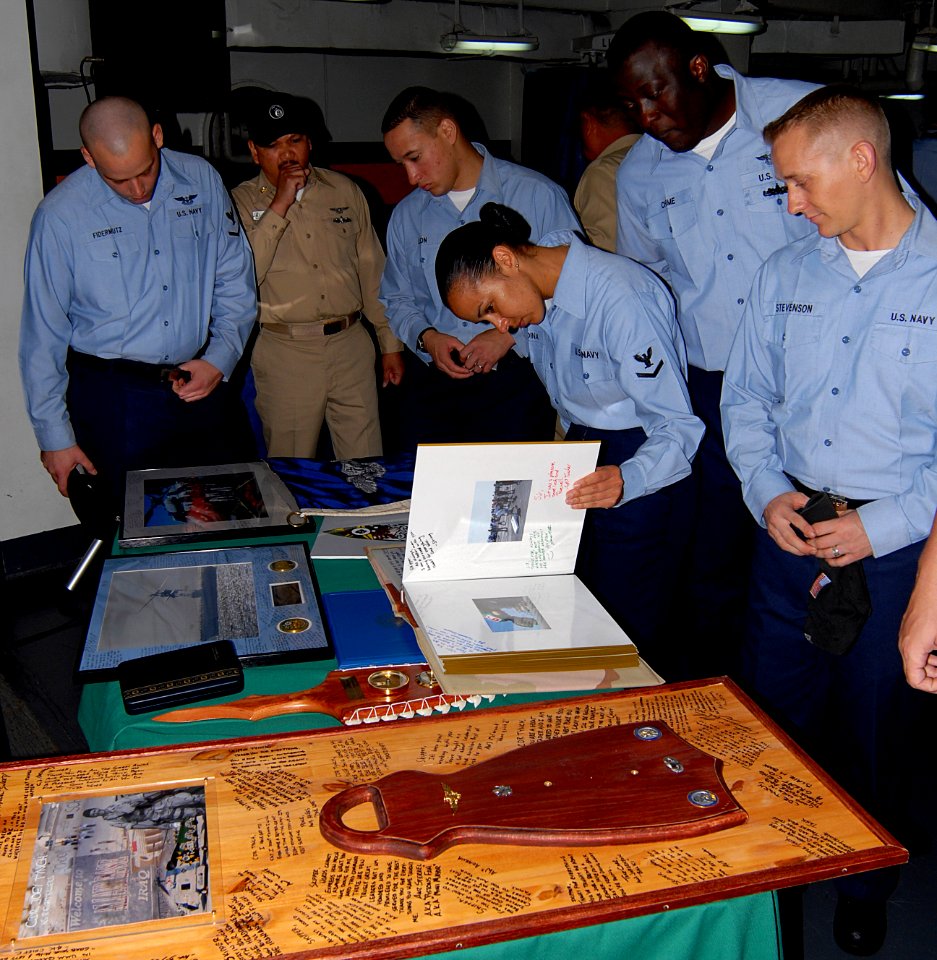US Navy 070512-N-3038W-050 Sailors from the Eightballers of Helicopter Anti-Submarine Squadron (HS) 8 look at mementos of Cmdr. Murray Tynch's career as commanding officer