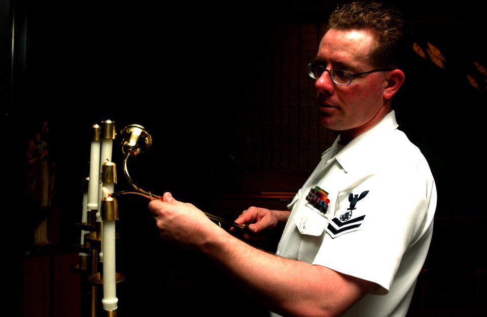 US Navy 070511-N-2143T-002 Religious Program Specialist 2nd Class Everette Dierflinger assigned to religious ministries staff, lights candles in the Bangor chapel