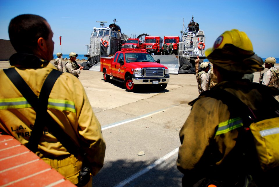 US Navy 070511-N-4774B-178 Sailors assigned to Assault Craft Unit (ACU) 5 assist Los Angeles County Fire Department in unloading their firefighting equipment from a Landing Craft Air Cushion (LCAC) on Catalina Island
