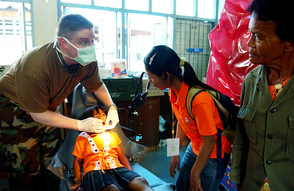 US Navy 070509-F-7806C-012 Navy Lt. Cmdr. Patterson, of Operational Support Hospital Unit, provides dental care to a Thai patient during the Cobra Gold 2007