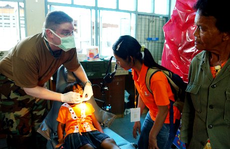 US Navy 070509-F-7806C-012 Navy Lt. Cmdr. Patterson, of Operational Support Hospital Unit, provides dental care to a Thai patient during the Cobra Gold 2007 photo