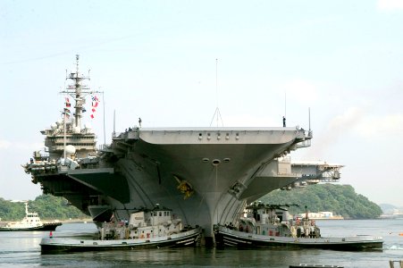 US Navy 070515-N-0483B-001 Large Harbor tugs assist USS Kitty Hawk (CV 63) as she departs Commander Fleet Activities to conduct sea trials
