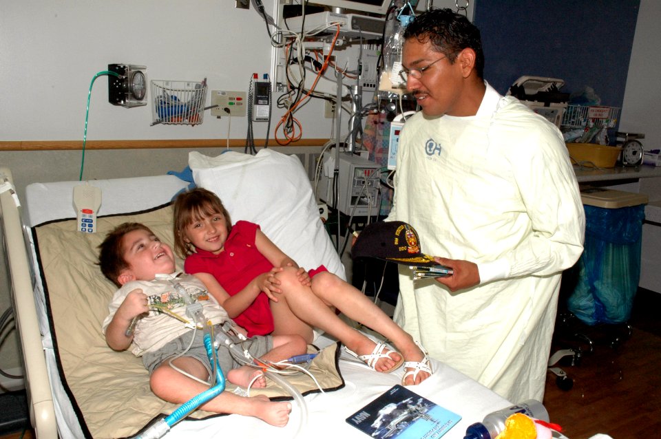 US Navy 070511-N-7975R-002 Seaman Alex Franco presents a USS Winston S. Churchill (DDG 81) Navy ball cap to a patient and his sister at Children's Hospital of Philadelphia (CHOP) as part of the Navy's CAPS for Kids