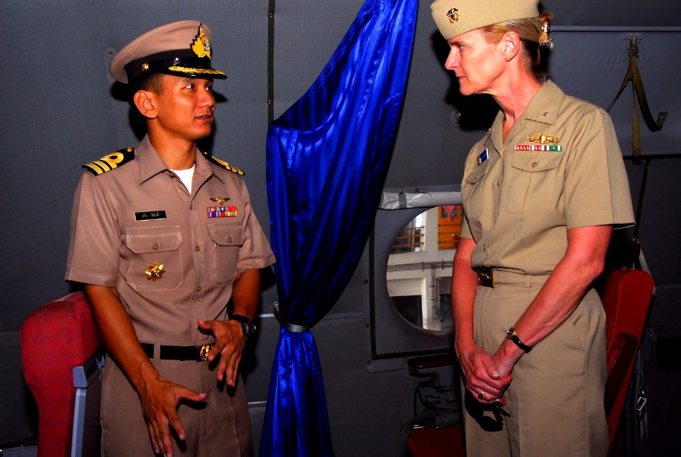 US Navy 070509-N-4124C-015 A Royal Thai Navy officer speaks with Expeditionary Strike Group (ESG) 7 Commander, Rear Adm. Carol M. Pottenger, about the capabilities of the Thai P-3 aircraft