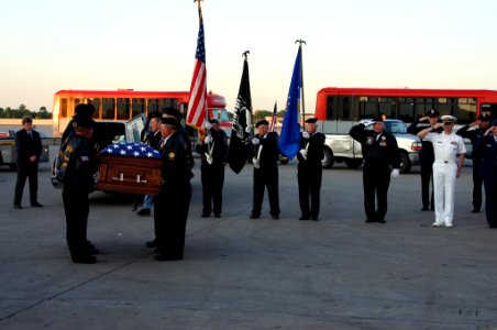 US Navy 070517-N-7163S-003 Lt. Cmdr. Brian Danielson and the Veterans Color Guard from Kenyon, Minn., render honors as the remains of Danielson's father, Air Force Maj. Benjamin Danielson, are prepared for transportation
