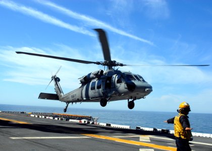 US Navy 070514-N-5033P-194 A Sailor guides a MH-60S Seahawk assigned to Helicopter Sea Combat (HSC) 22 onto the flight deck aboard the amphibious assault ship USS Kearsarge (LHD 3)