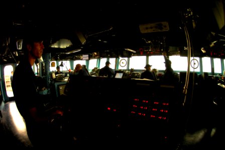 US Navy 070518-N-0684R-026 Seaman John Moen mans the helm during low visibility conditions caused by a sandstorm at sea aboard Arleigh Burke-class guided-missile destroyer USS Preble (DDG 88)