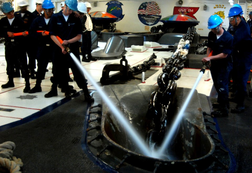 US Navy 070514-N-8923M-118 Sailors from deck department spray down an anchor chain as a wildcat pulls it in during a precision anchoring exercise in the forecastle aboard Nimitz-class aircraft carrier USS Harry S. Truman (CVN 7