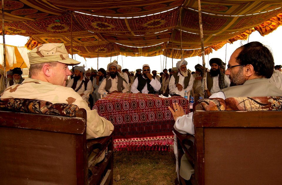 US Navy 070516-A-2013C-013 U.S. Navy Cmdr. Dave Adams and the Governor of Afghanistan's Khowst Province, Arsala Jamal, talk before the start of a ceremony in the District of Sabari