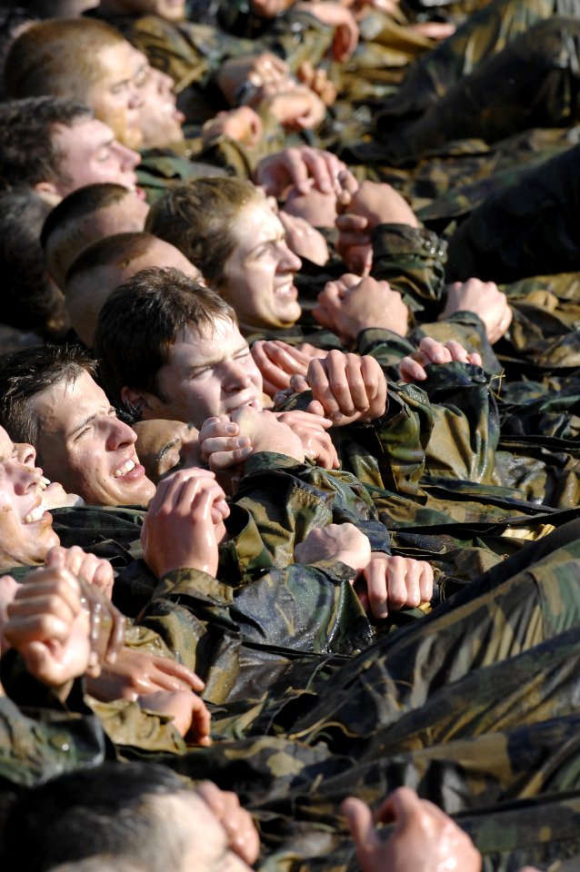 US Navy 070515-N-5390M-001 Midshipmen perform group crunches in the surf of the Severn River during Sea Trials at the U.S. Naval Academy.