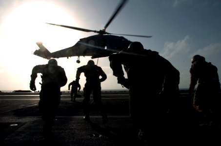 US Navy 070516-N-4420S-403 Sailors assigned to Explosive Ordinance Disposal Mobile Unit (EODMU) Detachment 3 run to an SH-60F Seahawk helicopter, assigned to the Indians of Helicopter Anti-Submarine Squadron (HS) 6, while pract