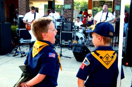 US Navy 070519-N-3750S-254 These guys are really great, says a cub scout from Pack 315 while singing along and playing air guitar with the band