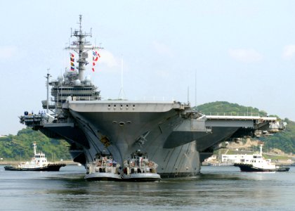 US Navy 070515-N-2638R-003 Large harbor tugs assist the USS Kitty Hawk (CV 63) as she departs Commander Fleet Activities Yokosuka to conduct sea trials
