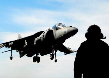 US Navy 070514-N-1831S-111 A Sailor assigned to Air Department aboard the amphibious assault ship USS Kearsarge (LHD 3) guides an AV-8B Harrier II from Marine Medium Helicopter Squadron (HMM) 26), reinforced, onto the flight de