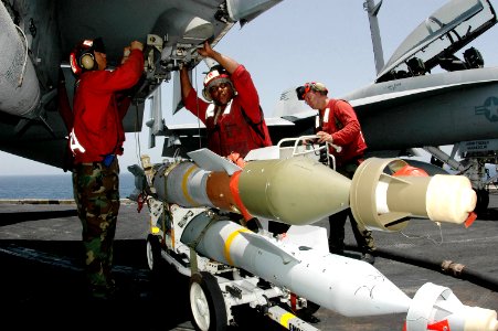 US Navy 070519-N-9760Z-003 Aviation Ordnanceman Airman Andrew Skyers, assigned to the Black Aces of Strike Fighter Squadron (VFA) 41, yells to stay clear in preparation to lift a GBU-12 laser guided bomb aboard nuclear-powered