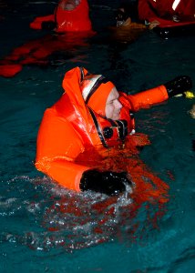 US Navy 070517-N-7656R-003 Sonar Technician (Submarine) 1st Class Stanley Lowe, assigned to USS Michigan (SSGN 727), learns how to use the Submarine Escape and Immersion Equipment (SEIE) MK-10 at the Naval Base Kitsap Fitness a
