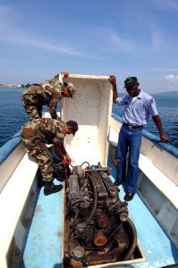 US Navy 070521-N-0989H-008 Honduran sailors inspect an engine for proper functions prior to using the vessel for small boat training with U.S. service members
