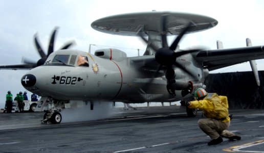 US Navy 070517-N-8923M-165 A shooter gives the signal to a catapult operator to launch an E-2C Hawkeye, from the Sun Kings of Carrier Airborne Early Warning Squadron (VAW) 116, off the bow of Nimitz-class aircraft carrier USS H