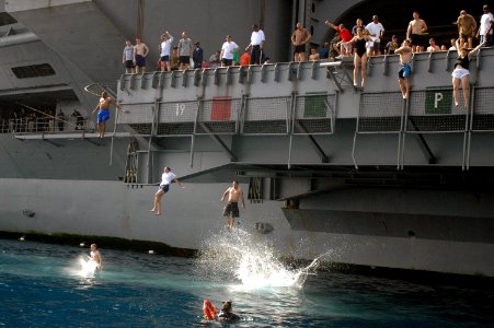 US Navy 070522-N-0890S-064 Sailors and Marines jump from elevator 3 during swim call aboard the nuclear-powered aircraft carrier USS Nimitz (CVN 68)