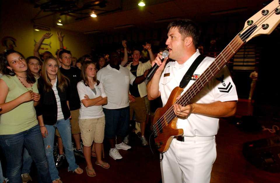 US Navy 070522-N-3750S-111 Musician 2nd Class Jeremy Middleton, bassist and unit leader for Navy Band Southeast group Pride, rocks a crowd of students from Northwest Cabarrus High School