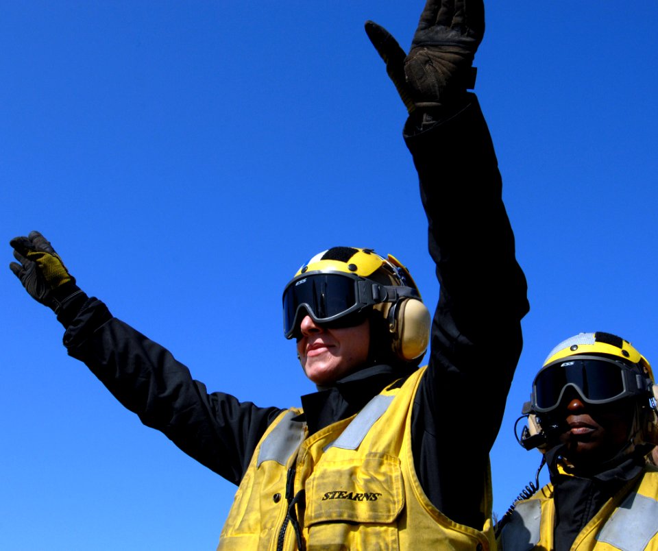 US Navy 070519-N-5345W-147 Aviation Boatswain's Mate (Handling) 3rd Class Erin Altuna signals for an EA-6B Prowler to taxi forward on the flight deck of Nimitz-class aircraft carrier USS Harry S. Truman (CVN 75)