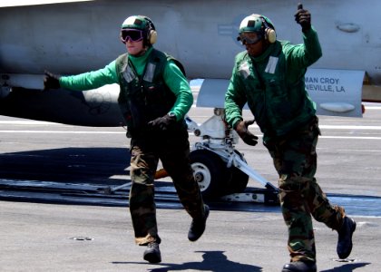 US Navy 070517-N-6854D-002 Two hold back operators run clear before an F-A-18C Hornet, from the Rampagers of Strike Fighter Squadron (VFA) 83, launches from Nimitz-class aircraft carrier USS Dwight D. Eisenhower (