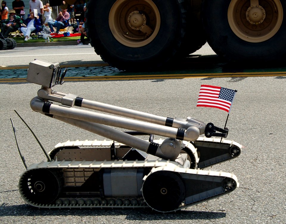 US Navy 070519-N-9706M-004 A robot belonging to the Joint Improvised Explosive Device Defeat Organization carries the United States Flag during the 48th Annual City of Torrance Armed Forces Day Parade