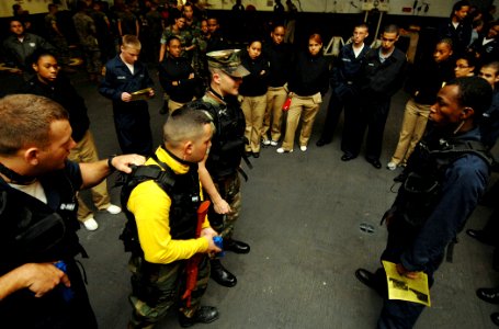 US Navy 070522-N-8923M-061 U.S. Navy Sea Cadets watch as Sailors from Security Department demonstrate different positioning techniques aboard the multi-purpose amphibious assault ship USS Wasp (LHD 1)