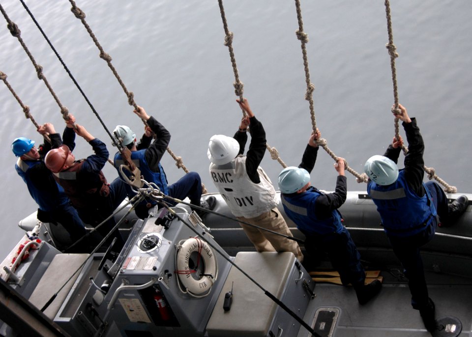 US Navy 070523-N-2910W-132 Sailors from Deck Department's 1st Division guide the Rigid Hull Inflatable Boat aboard the Nimitz-class aircraft carrier USS Abraham Lincoln (CVN 72) during a search and rescue exercise