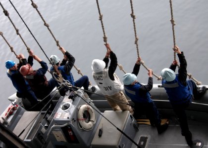 US Navy 070523-N-2910W-132 Sailors from Deck Department's 1st Division guide the Rigid Hull Inflatable Boat aboard the Nimitz-class aircraft carrier USS Abraham Lincoln (CVN 72) during a search and rescue exercise photo