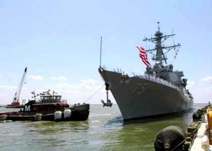 US Navy 070519-N-1713L-040 A tugboat pulls guided missile destroyer USS Donald Cook (DDG 75) away from the pier at Norfolk harbor