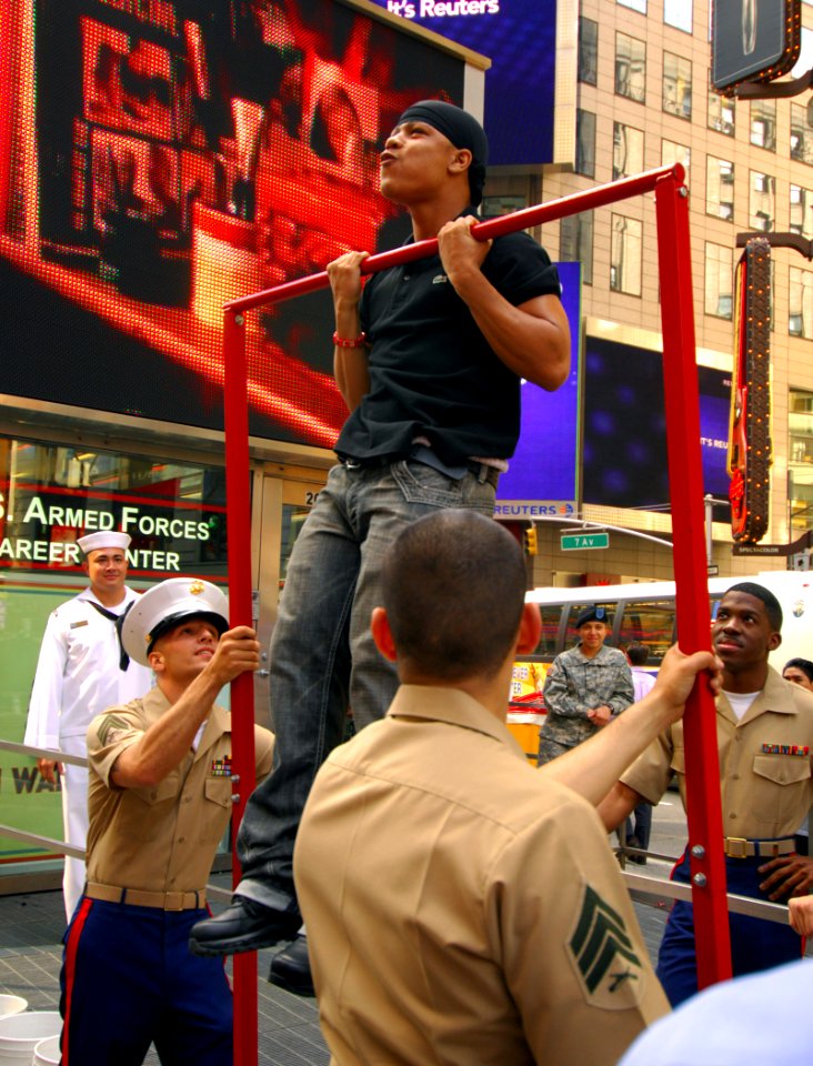 US Navy 070523-N-2984R-108 Military personnel assigned to U.S. Armed Forces Career Center on Times Square New York, watch as a New Yorker does pull-ups during an event where people from the city signed up to show off their phys