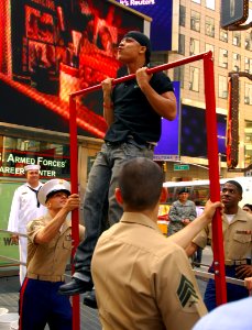 US Navy 070523-N-2984R-108 Military personnel assigned to U.S. Armed Forces Career Center on Times Square New York, watch as a New Yorker does pull-ups during an event where people from the city signed up to show off their phys