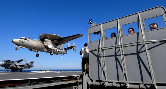 US Navy 070519-N-5345W-161 Landing signal officers (LSO) and lookouts watch from behind the LSO platform barricade as an E-2C Hawkeye, from the