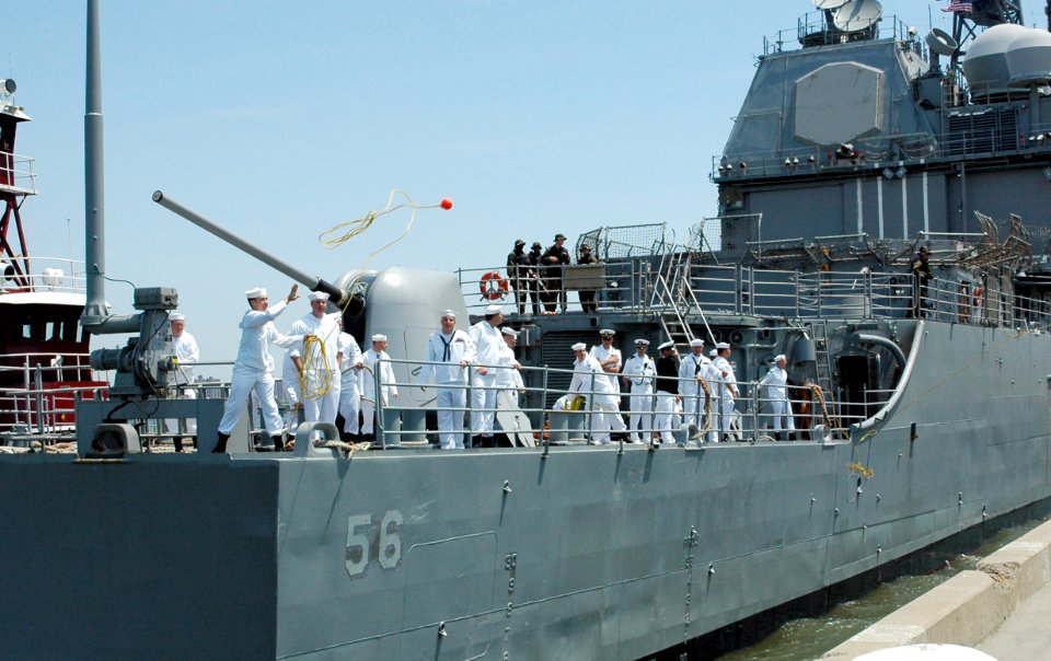 US Navy 070523-N-6812T-008 A Sailor tosses out a mooring line from USS San Jacinto (CG 56) as the guided missile cruiser moors at Staten Island's Stapleton Pier
