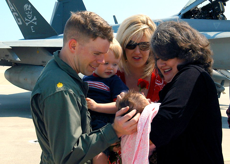US Navy 070522-N-1082Z-001 Lt. Cmdr. Clark Childers assigned to the Jolly Rogers of Strike Fighter Squadron (VFA) 103, greets his family