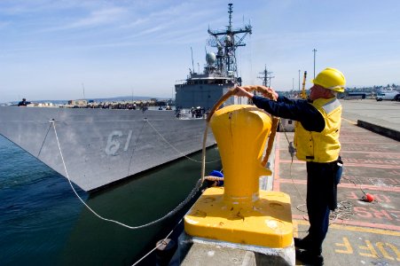US Navy 070518-N-3390M-004 Boatswain's Mate 2nd Class Randal Walters, assigned to guided missile destroyer USS Shoup (DDG 86), secures forward mooring lines to a bollard as guided missile frigate USS Ingraham (FFG 61) pre