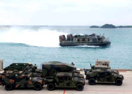 US Navy 070522-N-5067K-021 A landing craft air cushion (LCAC) from Assault Craft Unit (ACU) 5 flies past vehicles from the 31st Marine Expeditionary Unit (MEU) en route to amphibious transport dock USS Juneau (LPD 10)