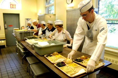 US Navy 070524-N-8467N-002 Seaman Apprentice Christopher Clement prepares trays at Holy Apostles Soup Kitchen in Manhattan