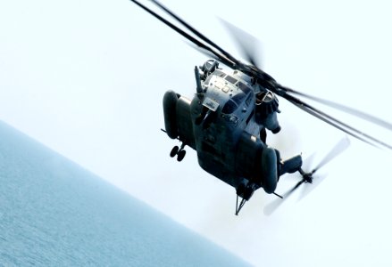 US Navy 070521-N-8923M-241 A CH-53E Super Stallion hovers above the flight deck of amphibious assault ship USS Wasp (LHD 1) photo