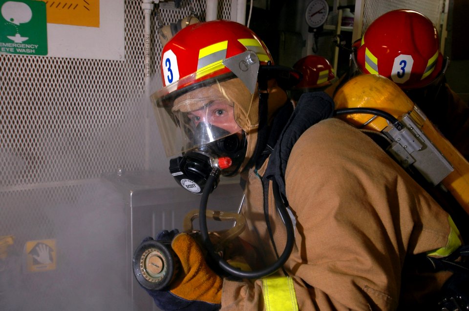 US Navy 070519-N-7883G-006 Hose team members practice firefighting during a general quarters (GQ) drill in the ship's laundry room aboard guided-missile destroyer USS Stethem (DDG 63)