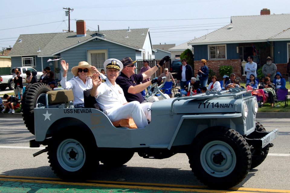 US Navy 070519-N-9706M-009 Commander, Navy Recruiting District Los Angeles Cmdr. Rob DeSantis, his wife and the driver, retired Navy Cmdr. Dave Rupp, wave to crowd lining the streets near the grandstand at the 48th Annual City
