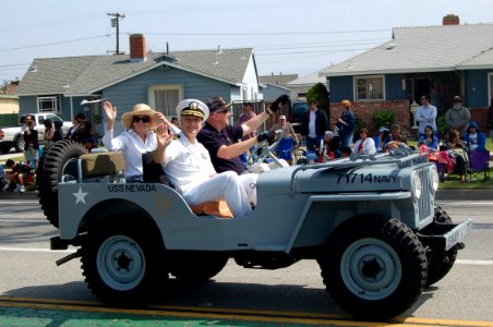 US Navy 070519-N-9706M-009 Commander, Navy Recruiting District Los Angeles Cmdr. Rob DeSantis, his wife and the driver, retired Navy Cmdr. Dave Rupp, wave to crowd lining the streets near the grandstand at the 48th Annual City